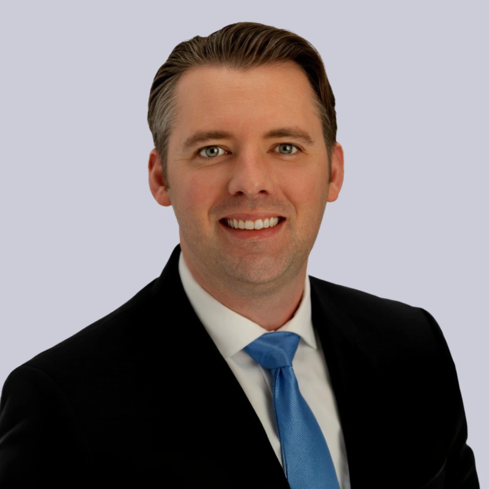 Professional portrait of Matt Rose, smiling in a suit and tie against a light background.