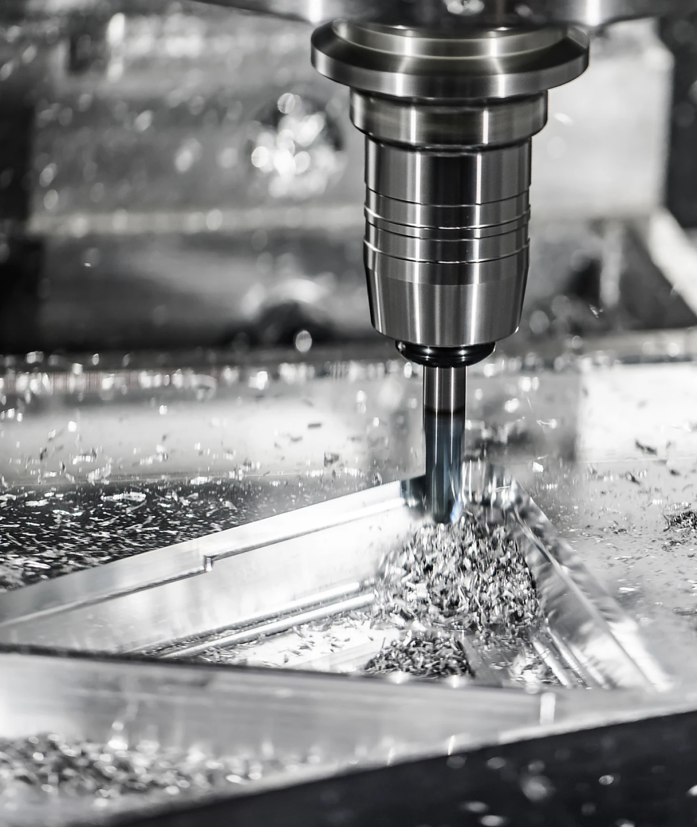 A precision machining tool cuts through metal, producing fine shavings and showcasing advanced manufacturing techniques.