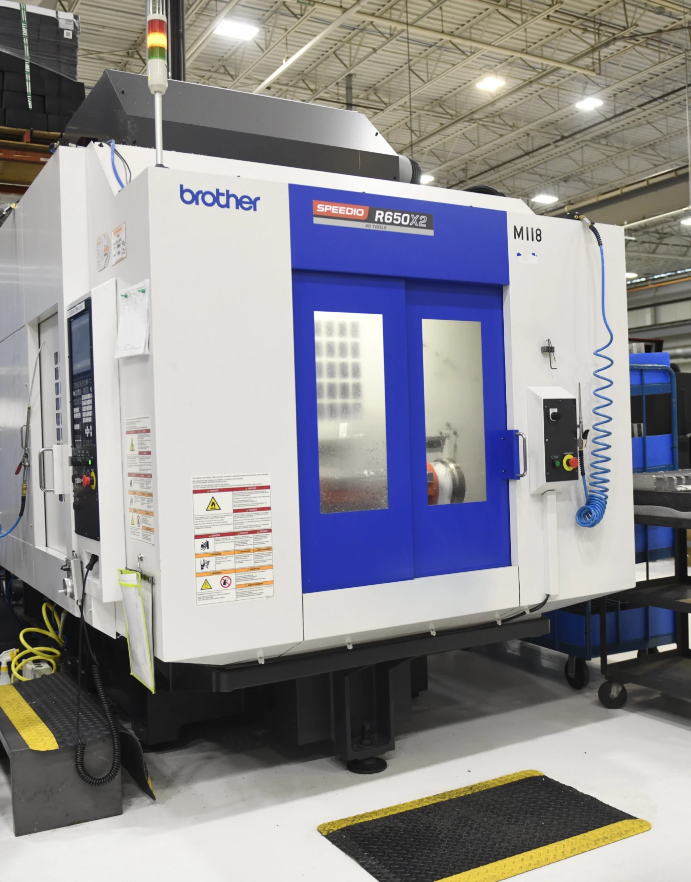 High-precision Brother Speedio R650X2 CNC machine in a manufacturing facility, showcasing advanced machining capabilities.